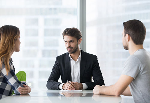 Unhappy husband and wife meeting California mediation lawyer in San Francisco Bay Area