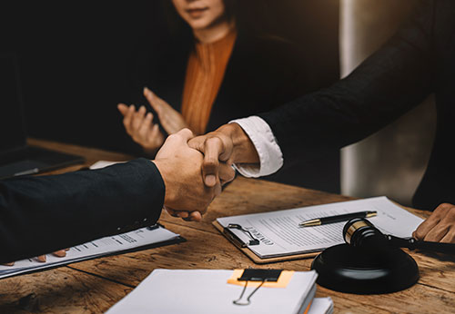 California mediation lawyers shaking hands after successful family law resolution