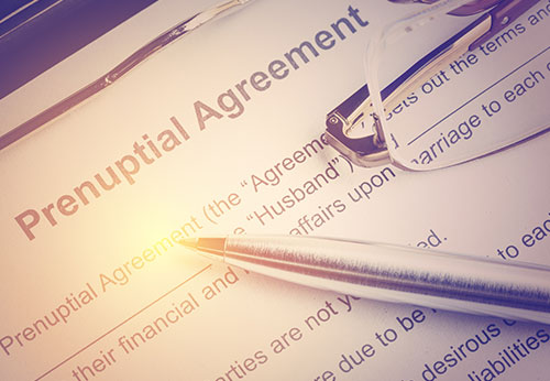 Silicon Valley tech entrepreneur reviewing prenuptial agreement with family lawyer